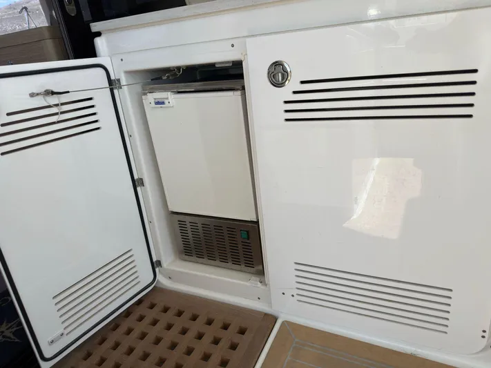 Gemini Yacht Photos Pics 2024 Lagoon 46 yacht interior with open storage compartment and ventilation panels.