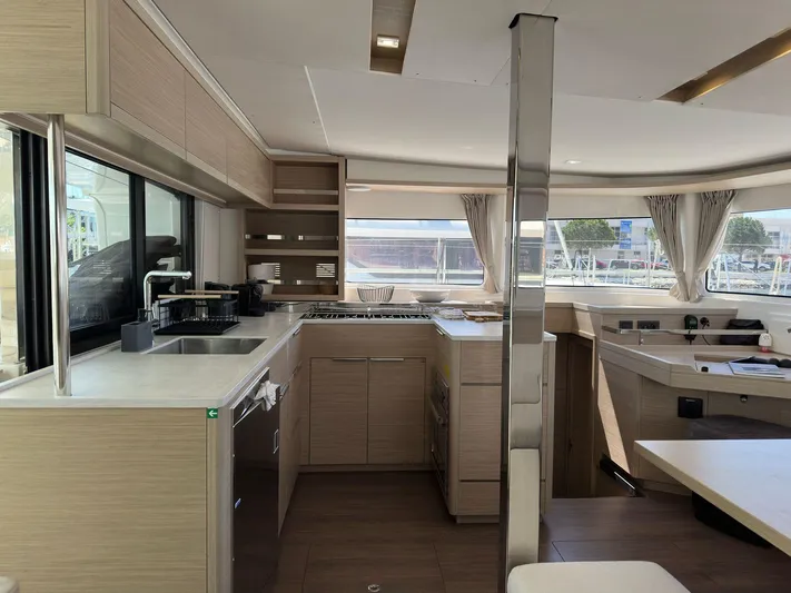 Gemini Yacht Photos Pics Interior of 2024 Lagoon 46 yacht, featuring modern kitchen and spacious seating area.