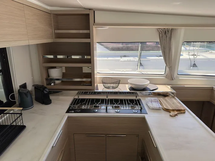 Gemini Yacht Photos Pics Modern kitchen interior of 2024 Lagoon 46 yacht with sleek countertops and appliances.