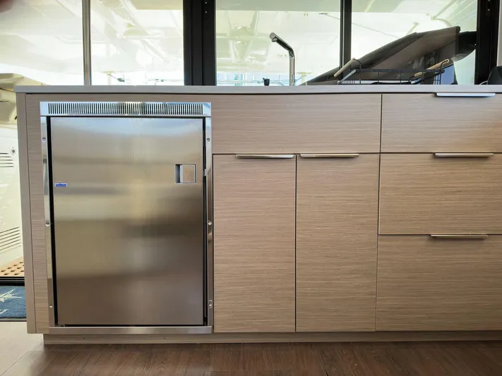 Gemini Yacht Photos Pics 2024 Lagoon 46 yacht interior with modern kitchen cabinetry and stainless steel appliances.