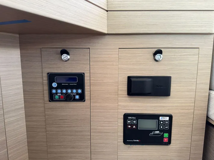 Gemini Yacht Photos Pics Control panels on 2024 Lagoon 46 yacht interior, featuring modern navigation and system displays.