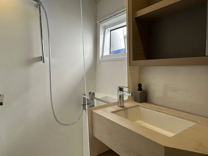 Gemini Yacht Photos Pics Modern bathroom in 2024 Lagoon 46 yacht with sleek sink and shower.