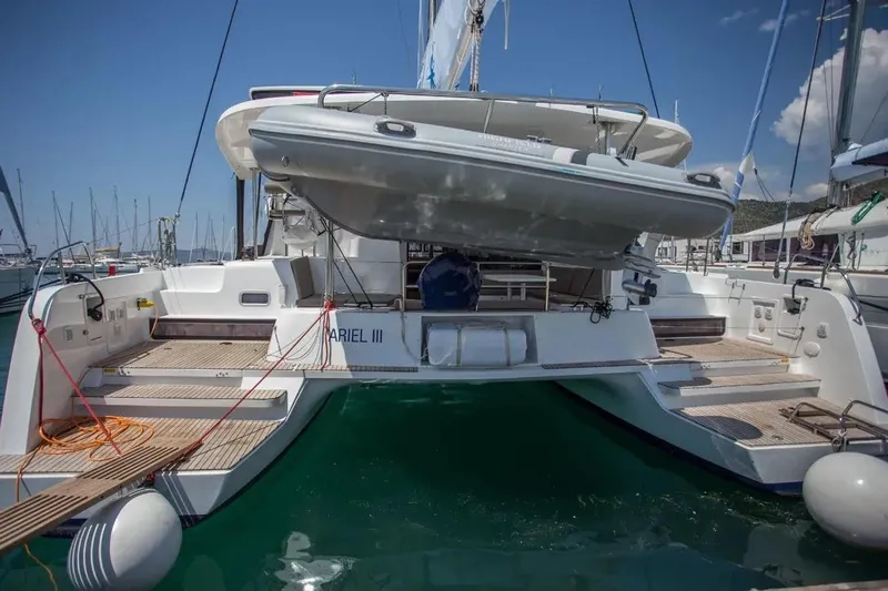 Ariel III Yacht Photos Pics 2018 Lagoon 42 catamaran docked, featuring spacious deck and tender boat.