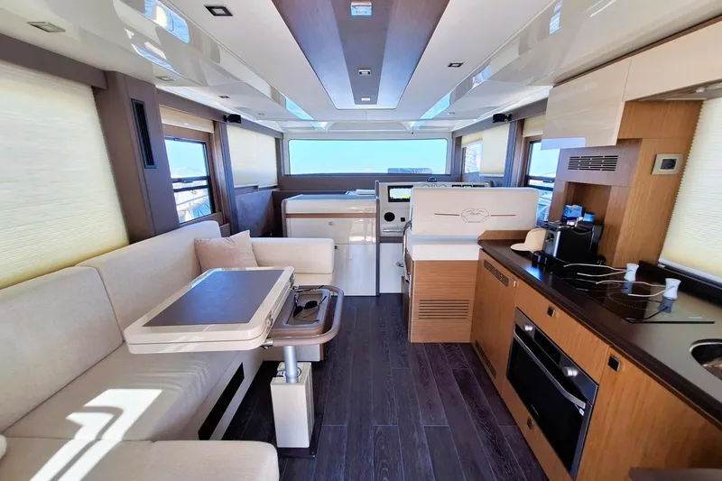  Yacht Photos Pics Luxurious interior of 2024 Cranchi T43 Eco Trawler with modern kitchen and seating area.