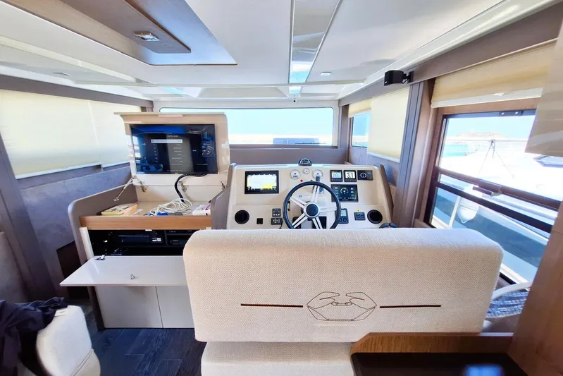  Yacht Photos Pics 2024 Cranchi T43 Eco Trawler helm with modern navigation equipment and panoramic windows.