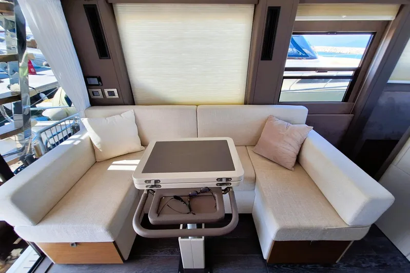  Yacht Photos Pics 2024 Cranchi T43 Eco Trawler interior with cozy seating and modern table.