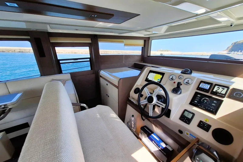  Yacht Photos Pics 2024 Cranchi T43 Eco Trawler helm with modern navigation instruments and panoramic windows.