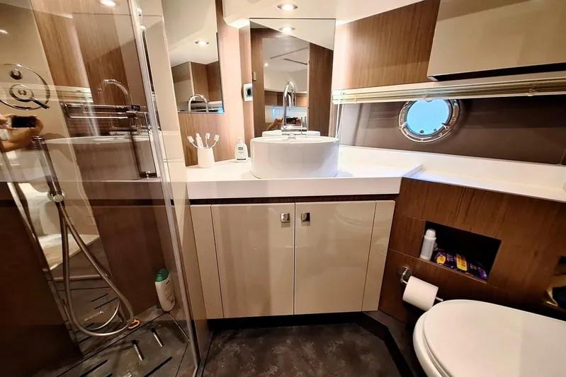  Yacht Photos Pics Luxurious bathroom in 2024 Cranchi T43 Eco Trawler yacht with modern fixtures.