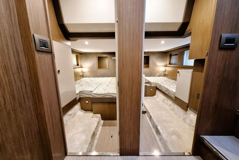  Yacht Photos Pics Luxurious interior of 2024 Cranchi T43 Eco Trawler with modern wood finishes and cozy bedding.
