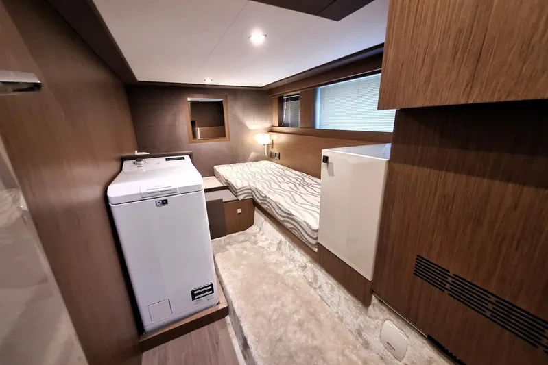  Yacht Photos Pics 2024 Cranchi T43 Eco Trawler cabin with modern wood interior and compact bed.