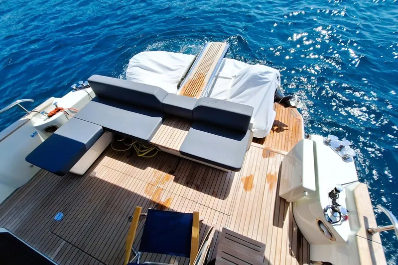  Yacht Photos Pics 2024 Cranchi T43 Eco Trawler deck with seating, overlooking blue ocean waters.