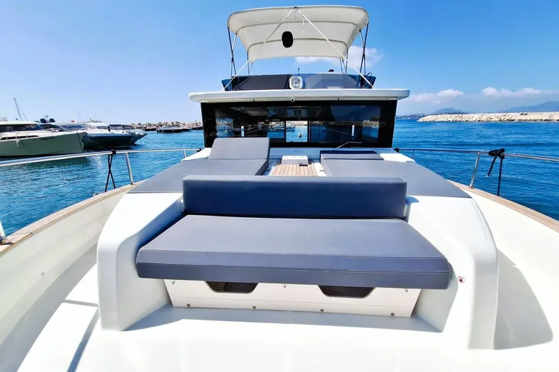  Yacht Photos Pics 2024 Cranchi T43 Eco Trawler on serene blue waters, showcasing sleek design and spacious deck.