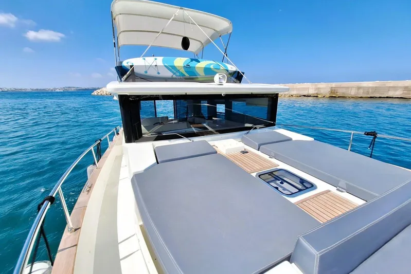  Yacht Photos Pics 2024 Cranchi T43 Eco Trawler on serene blue waters, showcasing spacious deck and modern design.