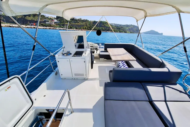  Yacht Photos Pics 2024 Cranchi T43 Eco Trawler deck with seating, table, and ocean view.