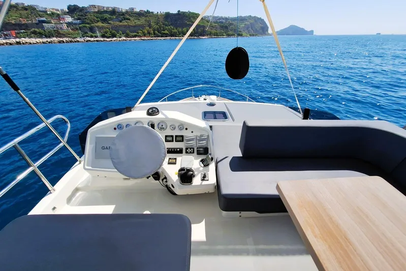  Yacht Photos Pics 2024 Cranchi T43 Eco Trawler helm with seating, overlooking scenic ocean view.