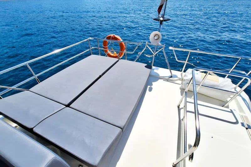  Yacht Photos Pics 2024 Cranchi T43 Eco Trawler sun deck with cushions and ocean view.