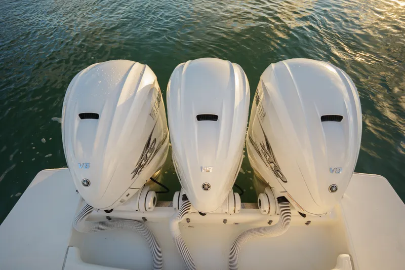  Yacht Photos Pics Triple Yamaha outboard engines on a 2020 Tiara Yachts 43 LS, docked on water.