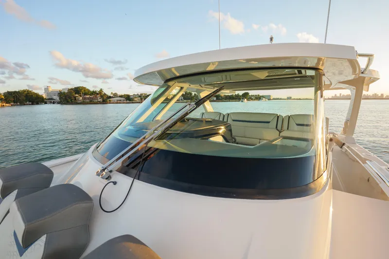  Yacht Photos Pics 2020 Tiara Yachts 43 LS on serene water at sunset, showcasing sleek design.