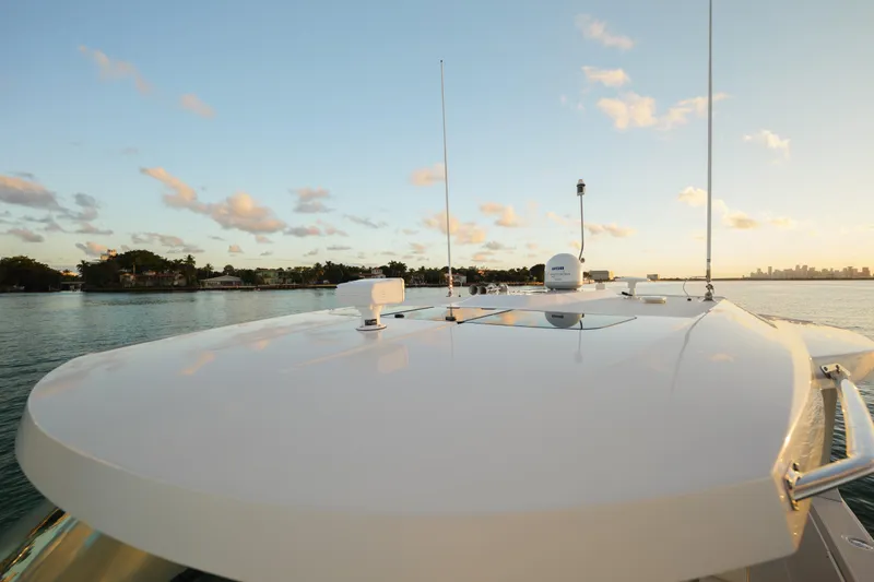  Yacht Photos Pics 2020 Tiara Yachts 43 LS on calm water at sunset, showcasing sleek design.