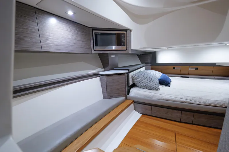  Yacht Photos Pics Luxurious interior of 2020 Tiara Yachts 43 LS with modern amenities and cozy bedding.