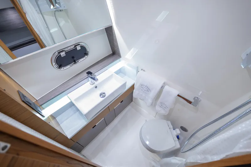  Yacht Photos Pics Luxurious bathroom in 2020 Tiara Yachts 43 LS, featuring modern sink and toilet.