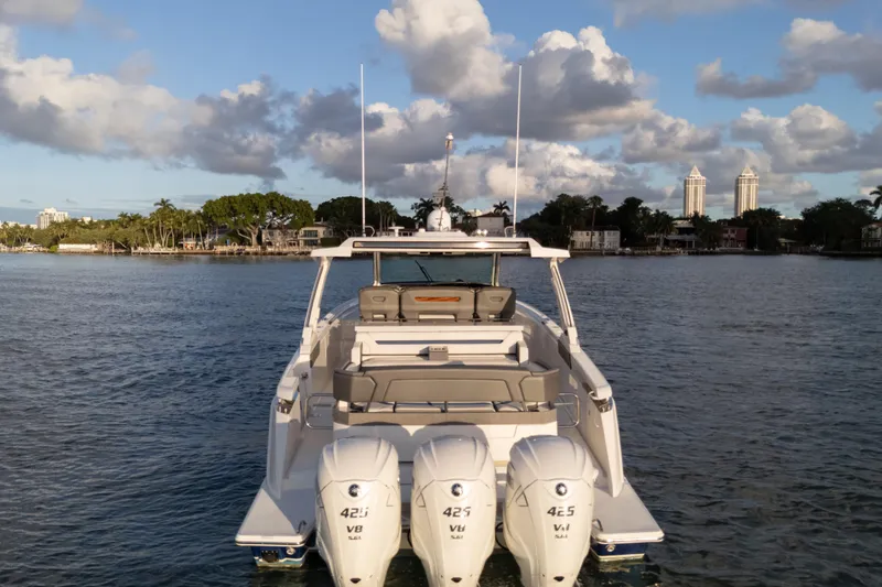  Yacht Photos Pics 2020 Tiara Yachts 43 LS boat on water with triple outboard engines.