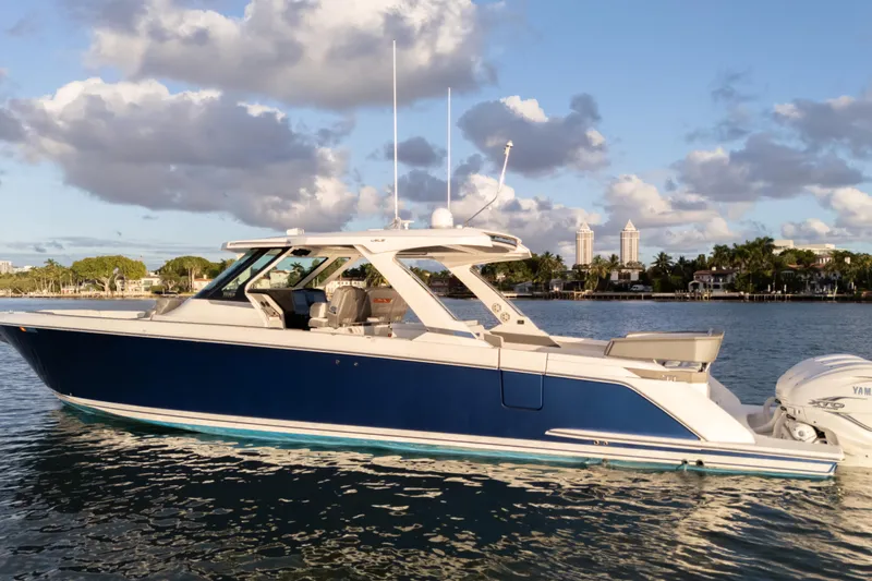  Yacht Photos Pics 2020 Tiara Yachts 43 LS boat on calm water with scenic background.