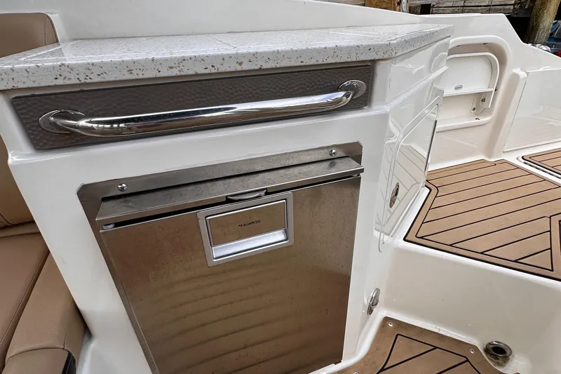  Yacht Photos Pics 2021 Sea Ray SDX 290 Outboard boat interior with Dometic fridge and stylish countertop.