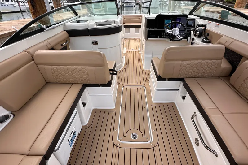  Yacht Photos Pics 2021 Sea Ray SDX 290 Outboard interior with tan seating and wood-style flooring.