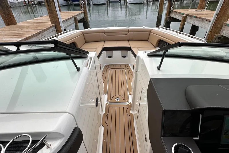 Yacht Photos Pics 2021 Sea Ray SDX 290 Outboard boat interior with tan seating and wooden deck.