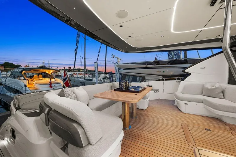 S72531 Yacht Photos Pics Luxurious 2025 Princess S72 yacht interior with elegant seating and wooden deck at sunset.