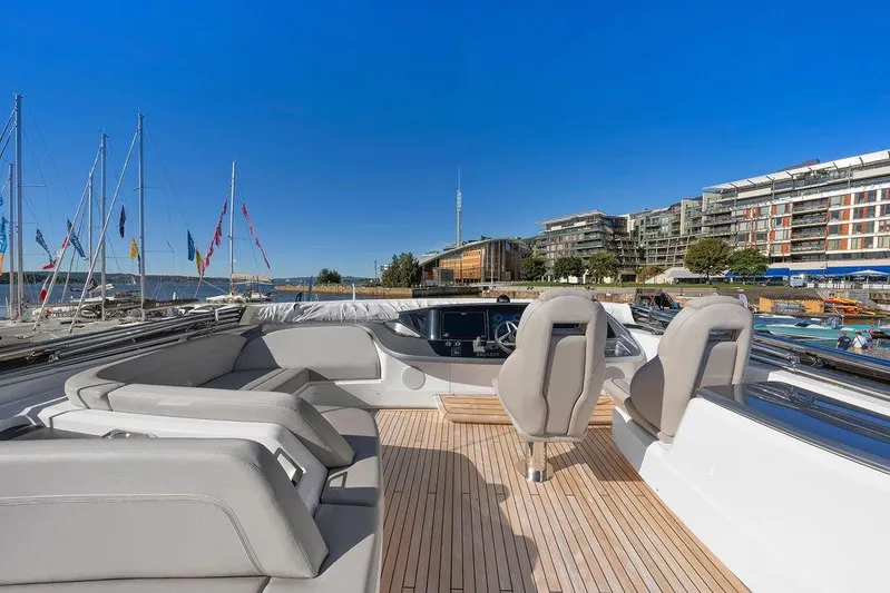 S72531 Yacht Photos Pics Luxurious 2025 Princess S72 yacht with sleek deck and modern seating in a marina setting.