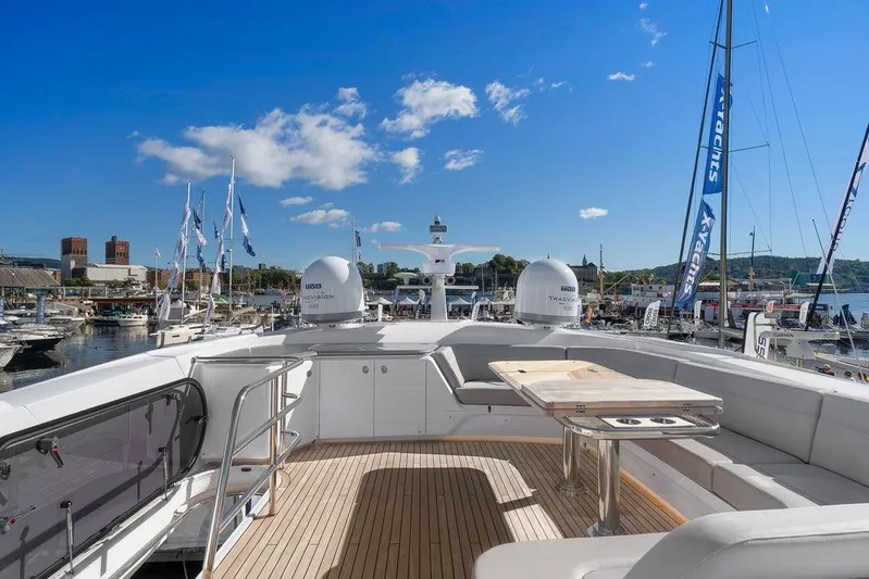 S72531 Yacht Photos Pics Luxurious 2025 Princess S72 yacht deck with seating, table, and marina view.