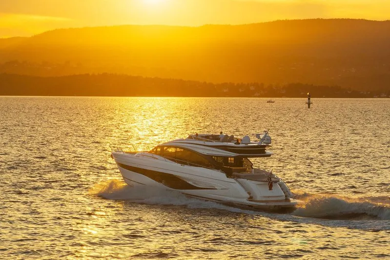 S72531 Yacht Photos Pics 2025 Princess S72 yacht cruising at sunset on a serene lake.