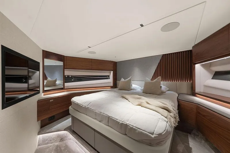 S72531 Yacht Photos Pics Luxurious bedroom interior of 2025 Princess S72 yacht with modern design and cozy bedding.