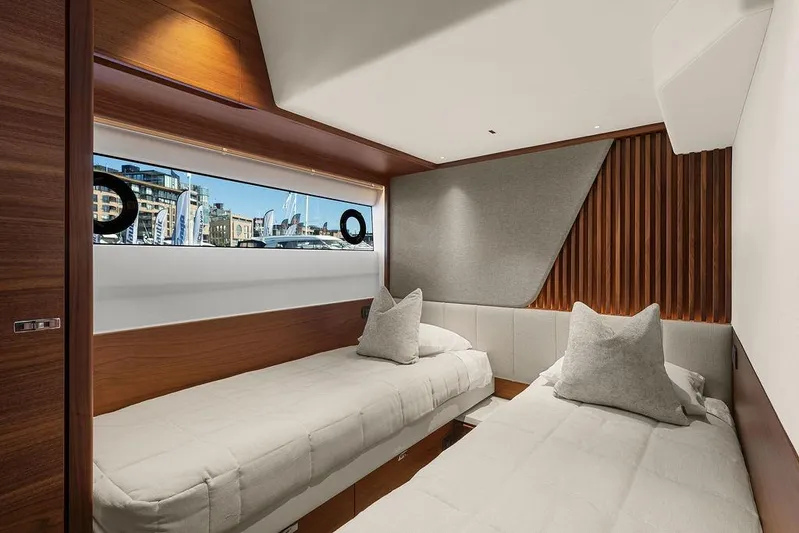 S72531 Yacht Photos Pics Luxurious 2025 Princess S72 yacht cabin with twin beds and modern wood paneling.