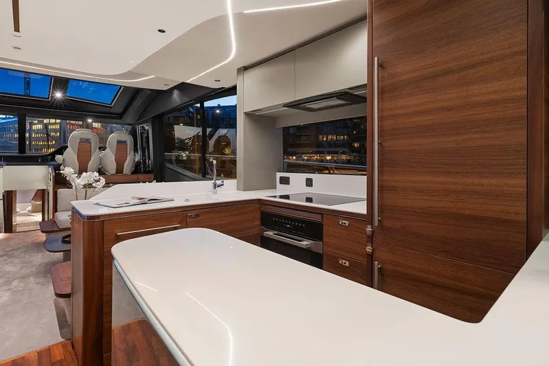 S72531 Yacht Photos Pics Luxurious interior of 2025 Princess S72 yacht with modern kitchen and elegant seating area.