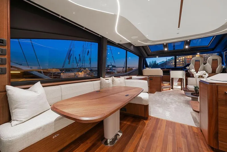 S72531 Yacht Photos Pics Luxurious interior of 2025 Princess S72 yacht with elegant wood finishes and modern seating.