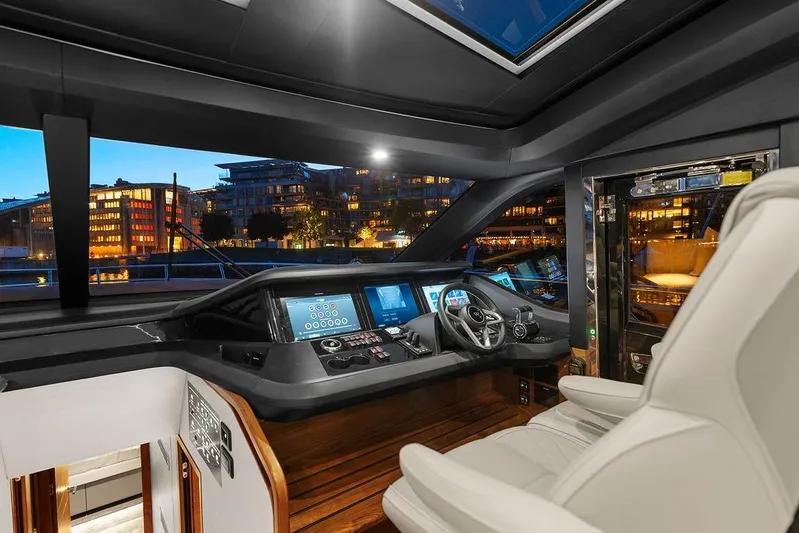 S72531 Yacht Photos Pics Luxurious 2025 Princess S72 yacht cockpit with modern controls and cityscape view.