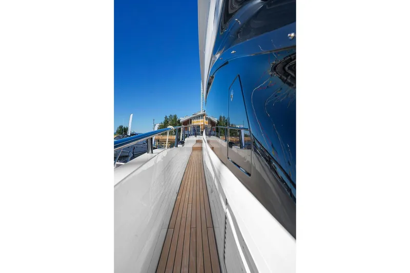 S72531 Yacht Photos Pics Side view of 2025 Princess S72 yacht with sleek design and wooden deck.