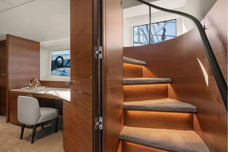 S72531 Yacht Photos Pics Luxurious interior of 2025 Princess S72 yacht with elegant wooden staircase and modern workspace.