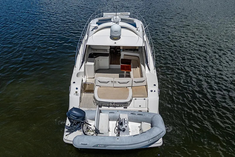 Yacht Photos Pics 2014 Sea Ray 470 Sundancer yacht with inflatable boat on water.