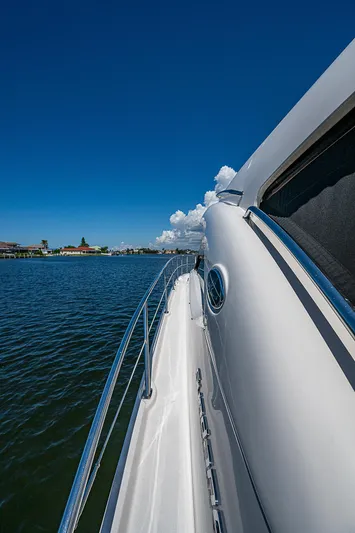  Yacht Photos Pics Side view of 2014 Sea Ray 470 Sundancer yacht on calm water under clear blue sky.