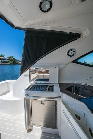  Yacht Photos Pics 2014 Sea Ray 470 Sundancer yacht kitchenette with sink, grill, and mini-fridge.