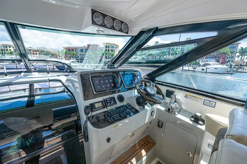  Yacht Photos Pics Interior helm of 2014 Sea Ray 470 Sundancer yacht with modern navigation equipment.