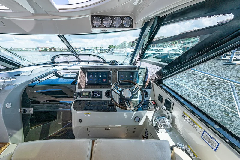  Yacht Photos Pics Interior helm of 2014 Sea Ray 470 Sundancer yacht with modern navigation equipment.