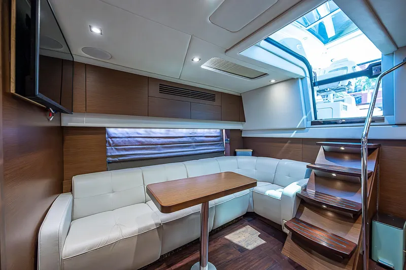  Yacht Photos Pics Luxurious interior of 2014 Sea Ray 470 Sundancer yacht with white seating and wooden accents.