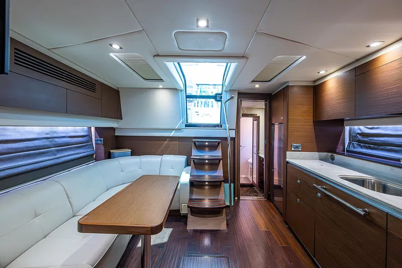  Yacht Photos Pics Luxurious interior of 2014 Sea Ray 470 Sundancer yacht with modern kitchen and seating area.