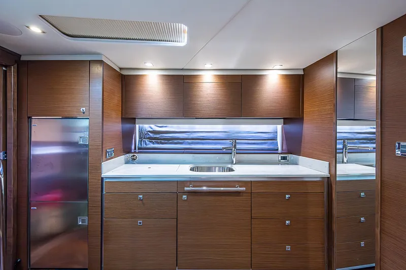  Yacht Photos Pics Luxurious 2014 Sea Ray 470 Sundancer yacht kitchen with modern wood cabinetry and sleek design.