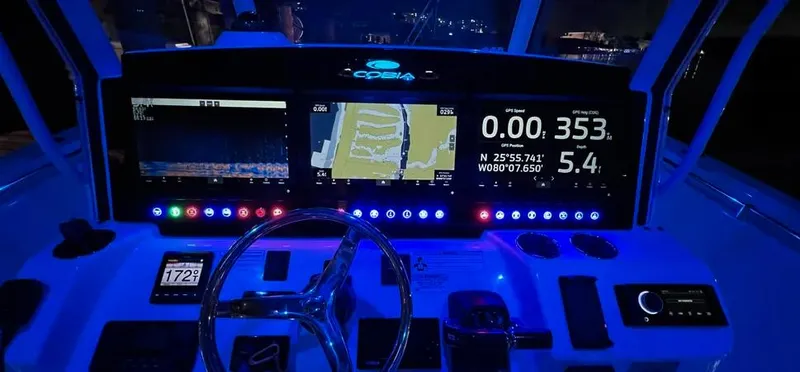 Yacht Photos Pics 2018 Cobia 344 Center Console dashboard with illuminated navigation screens at night.